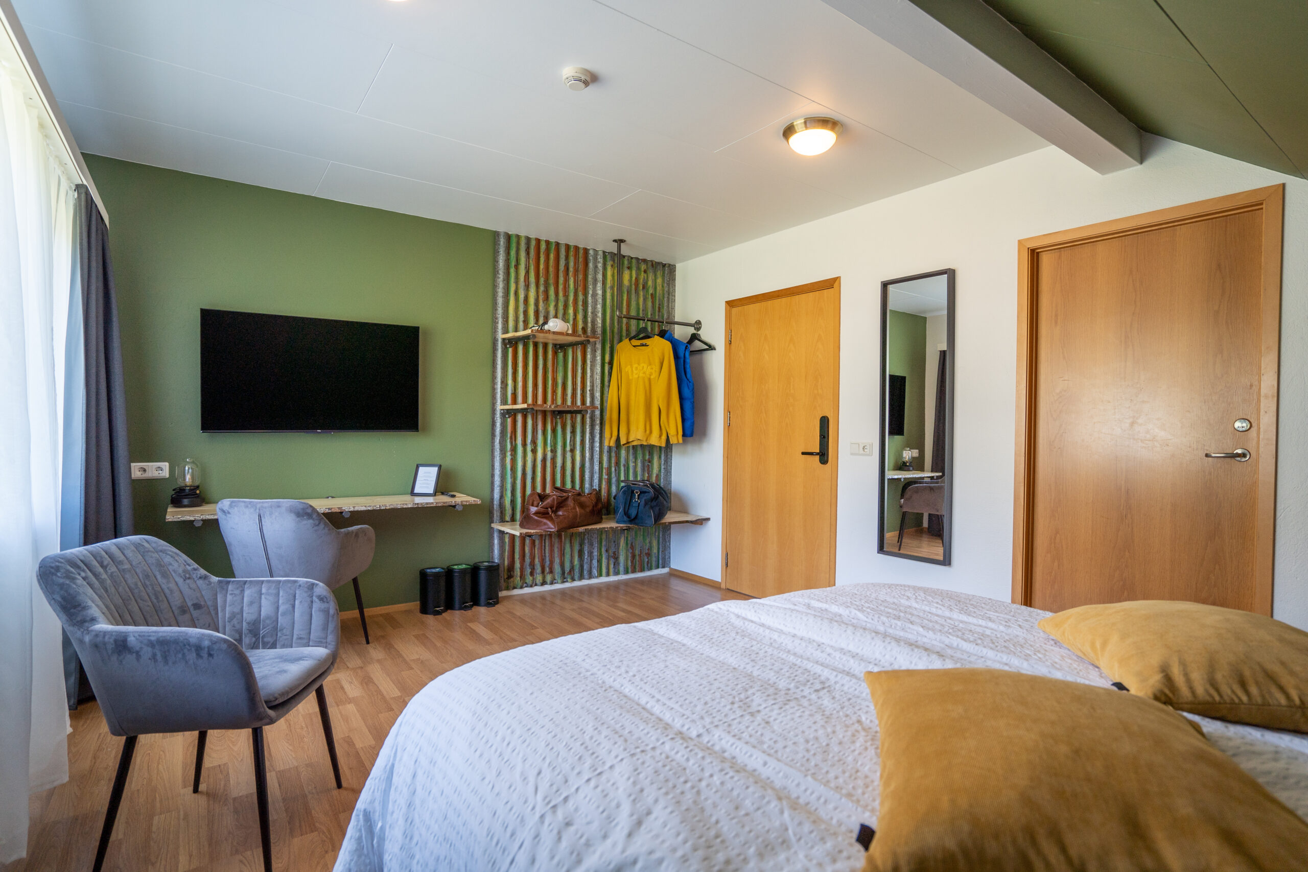 Hotel Room with TV and Green Walls