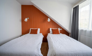 Cosy orange twin bedroom with two single beds, Hótel Breiðdalsvík East Iceland