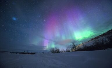Northern Lights over East Iceland fjord in winter